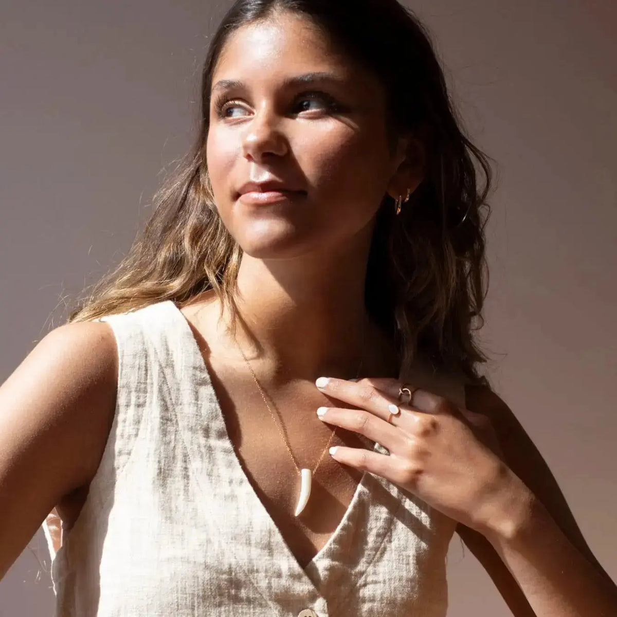 Mother of Pearl Tusk Necklace from Token Jewelry featuring a polished pearl-tusk pendant on a delicate chain.
