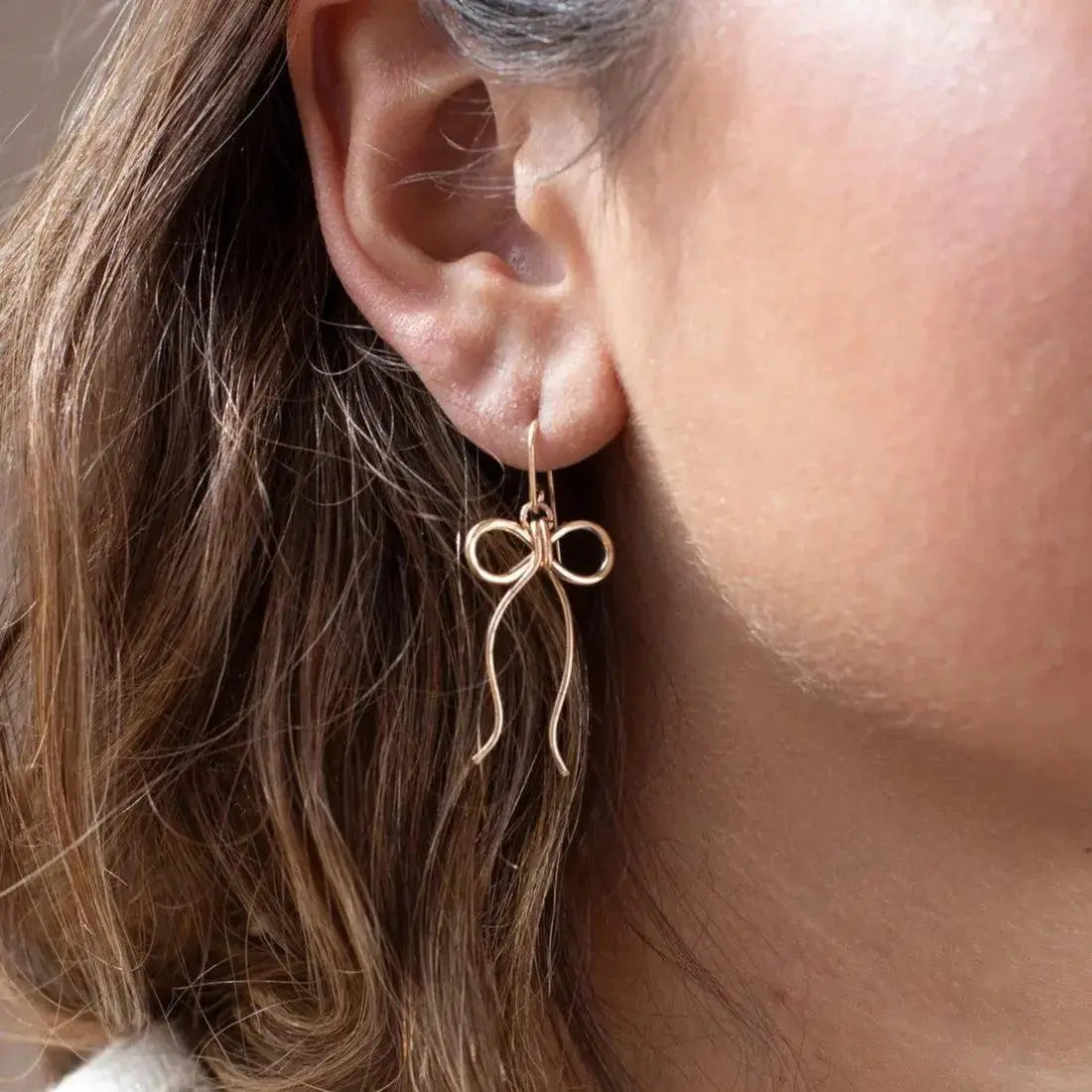 Silver Coquette Bow Earrings by Token Jewelry featuring delicate bow design and elegant jewelry style.