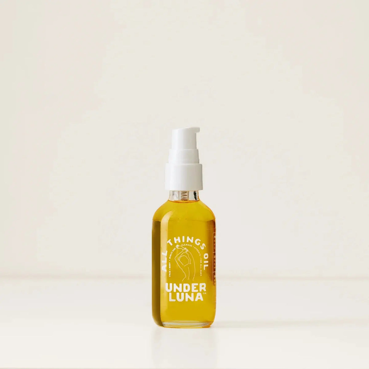 Under Luna All Things Oil body oil bottle with a pump dispenser, natural skincare product for moisturizing and nourishing skin.