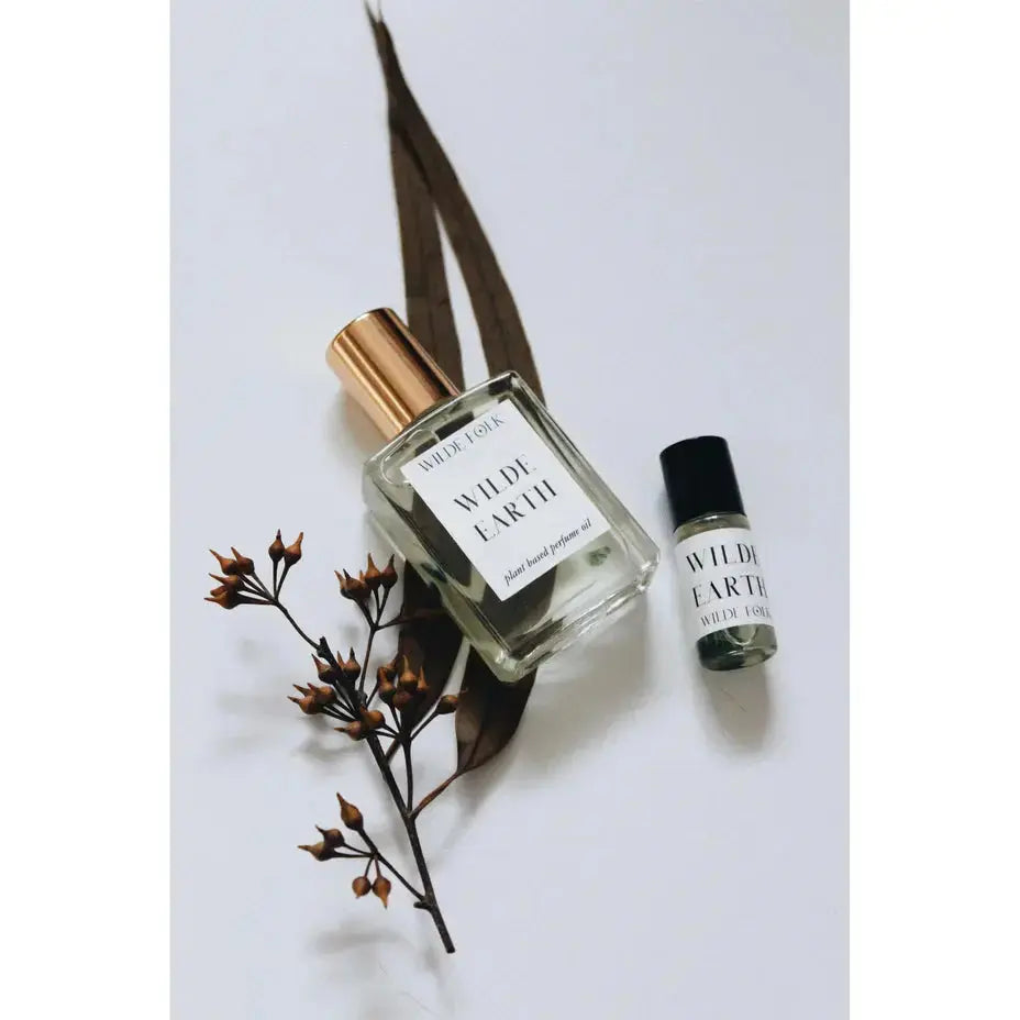 Wilde Earth perfume by Wilde Folk, featuring a sleek glass bottle with a minimalist design and natural earthy tones.