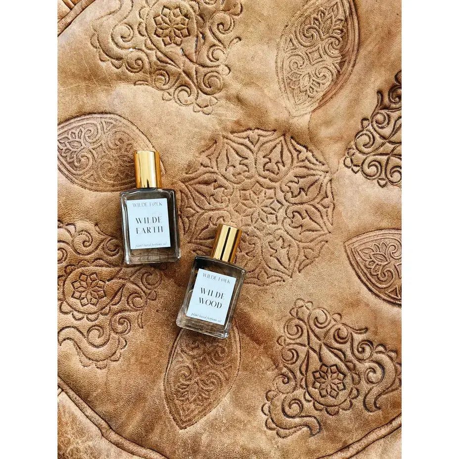 Wilde Earth perfume by Wilde Folk, a glass bottle with a minimalist label, showcasing the natural, earthy fragrance.