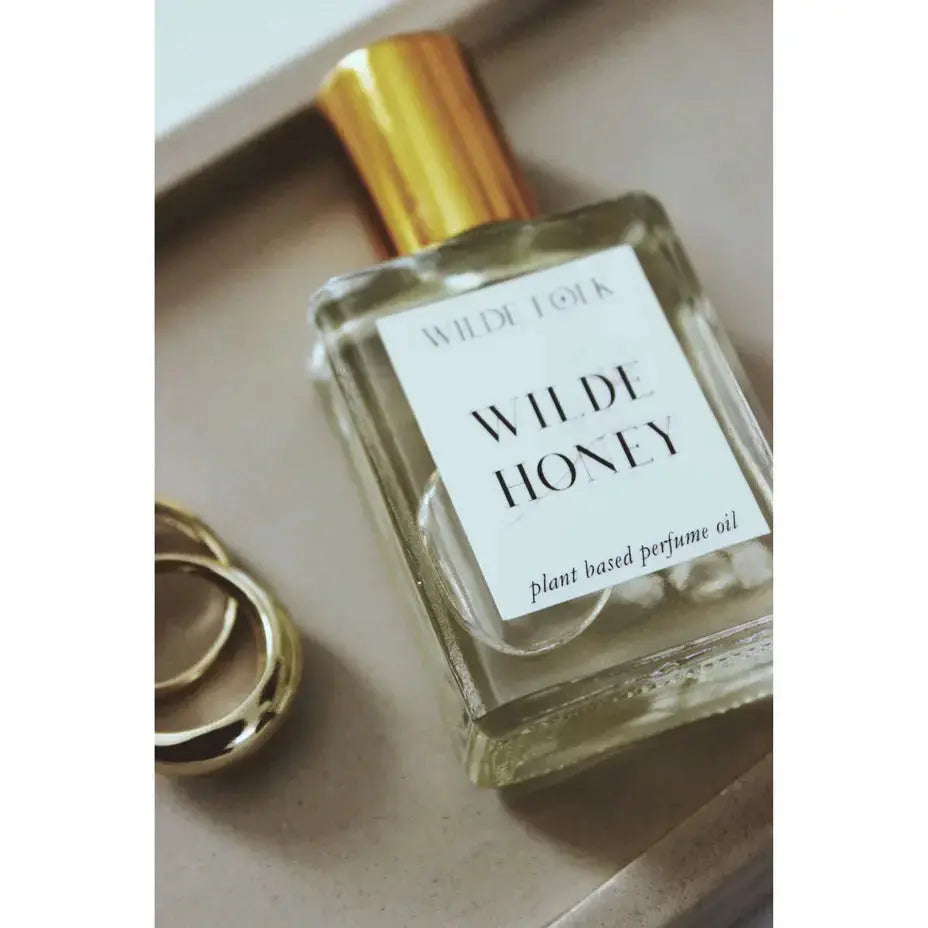 Wilde Honey perfume bottle by Wilde Folk with a sleek design, showcasing the elegant packaging and golden accents.