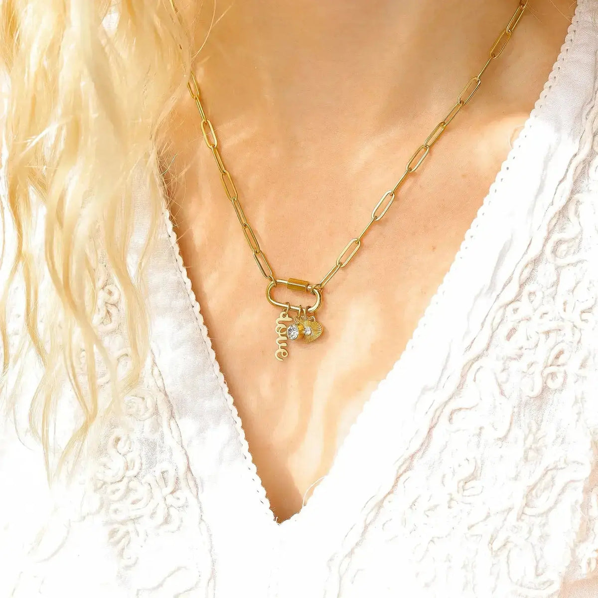 Gold Love Paperclip Charm Necklace by WJW featuring a delicate paperclip chain and a small heart-shaped charm.