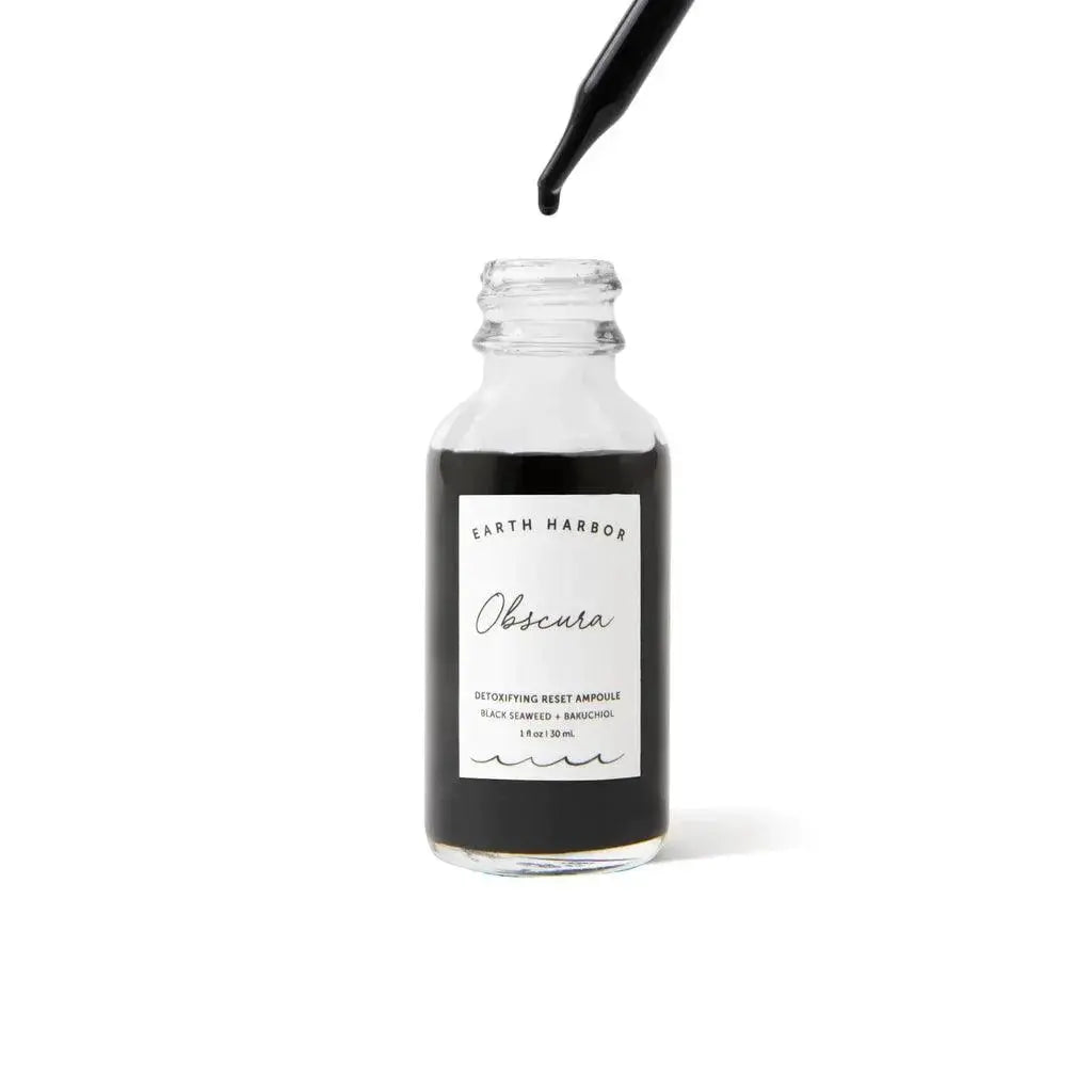 Earth Harbor Obscura Detoxifying Reset Ampoule, skincare product with clear glass bottle and dropper for revitalizing skin.
