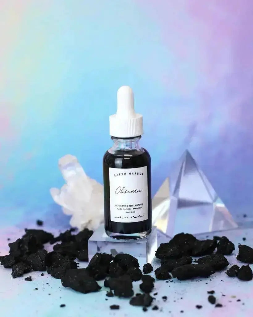 Earth Harbor Obscura Detoxifying Reset Ampoule in a glass bottle with dropper for skin care and detoxification.