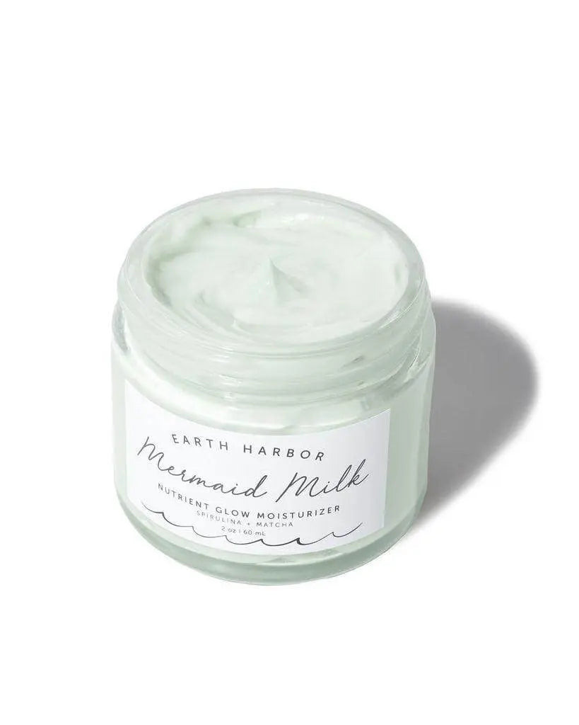 Earth Harbor Mermaid Milk nutrient glow moisturizer in a 2oz jar, showcasing the skincare product with a sleek container.