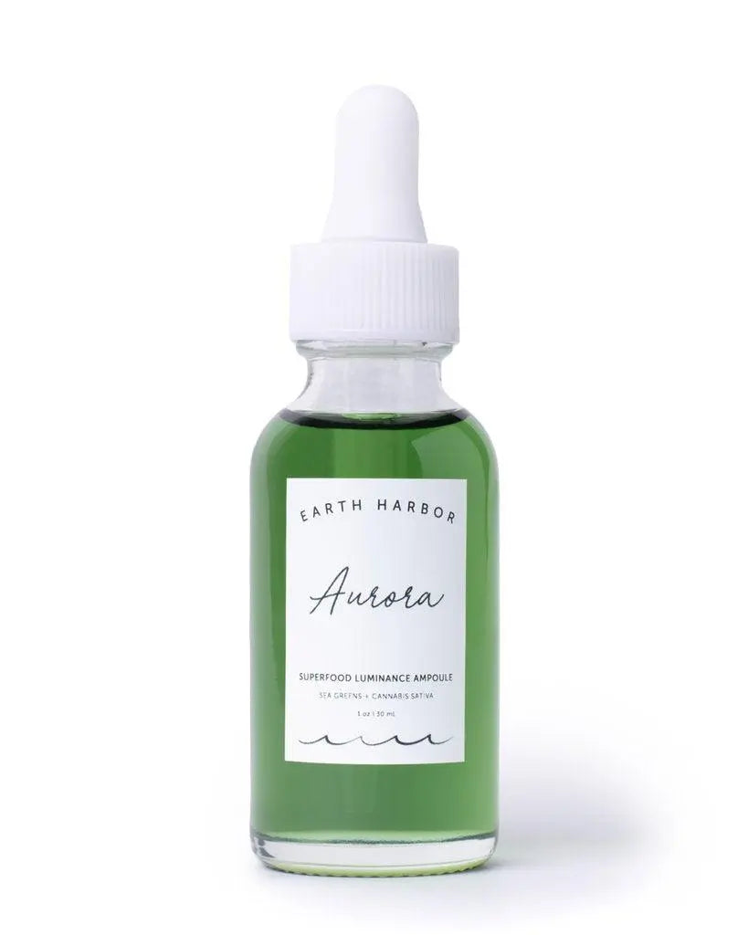 Earth Harbor Aurora Superfood Clarity Concentrate skincare serum in a glass bottle with a dropper applicator, featuring a natural, vibrant label.