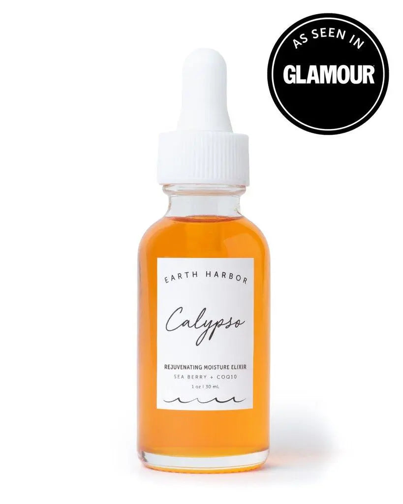 Earth Harbor Calyspo Antioxidant Glow Facial Oil in a glass dropper bottle, with fresh botanical ingredients visible around it.