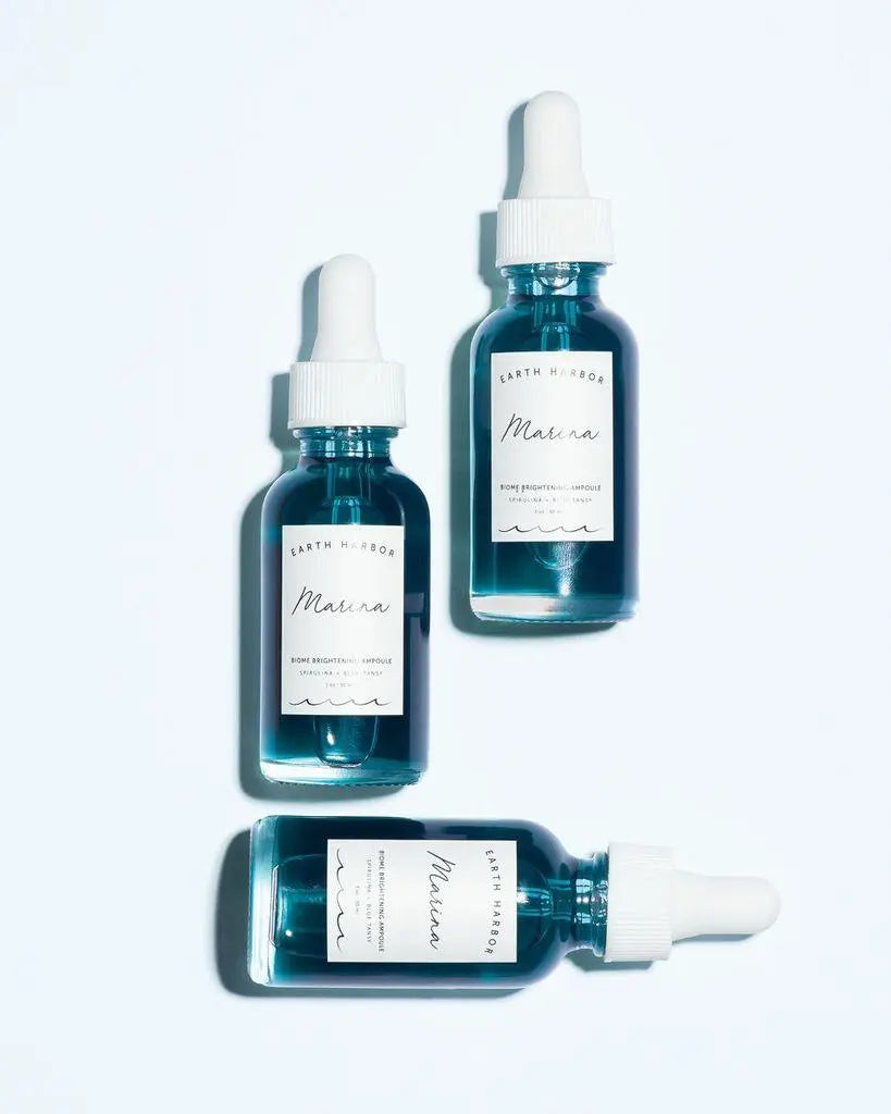 Earth Harbor Marina Biome Brightening Concentrate in a skincare bottle, showcasing the product's sleek packaging and clarity.