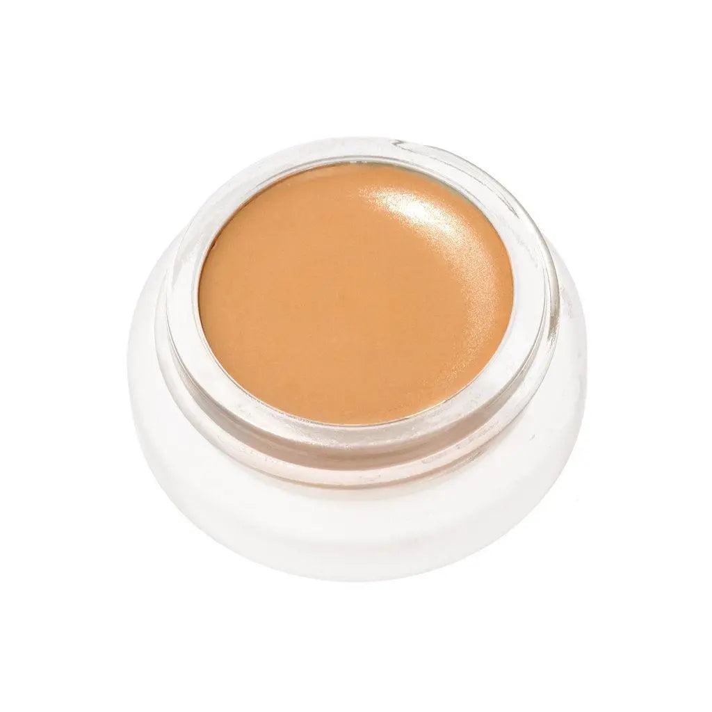 RMS Beauty UnCoverup Concealer in a compact container, showing the creamy beige cosmetic product for skin coverage.
