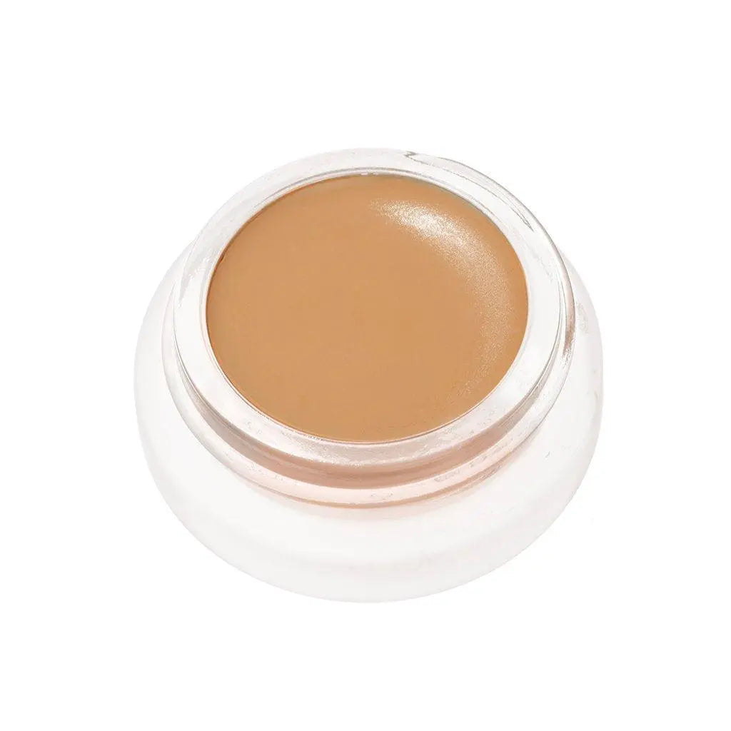 RMS Beauty UnCoverup Concealer in a compact container, showcasing the creamy cosmetic product for skin coverage.