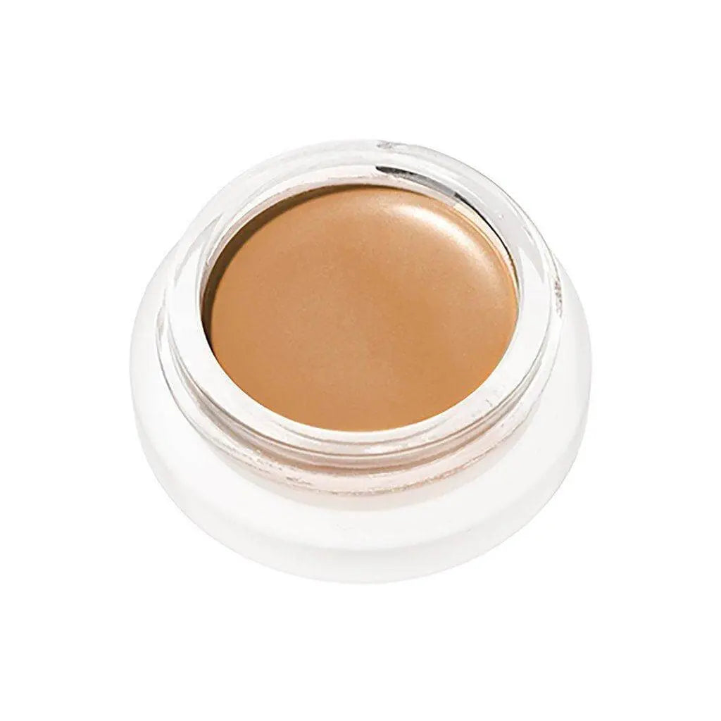 RMS Beauty UnCoverup Concealer in a compact container, showcasing the creamy cosmetic product for flawless skin coverage.