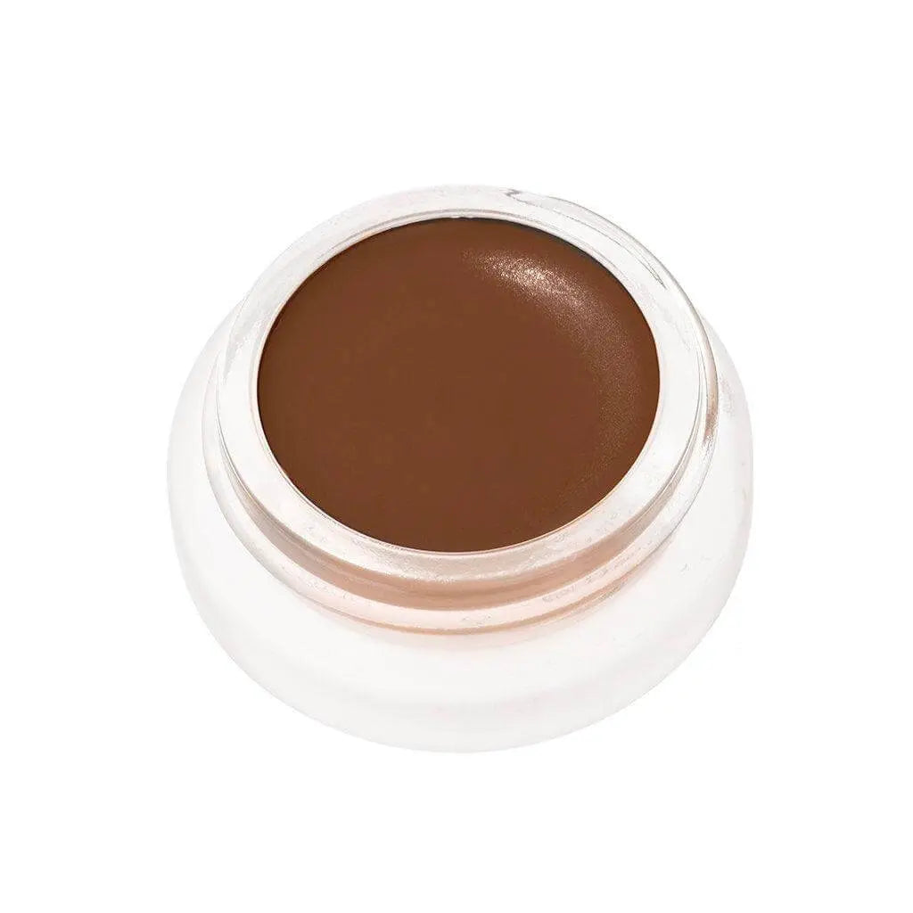 RMS Beauty UnCoverup Concealer in a compact container, showcasing creamy beige cosmetic product for skin coverage.