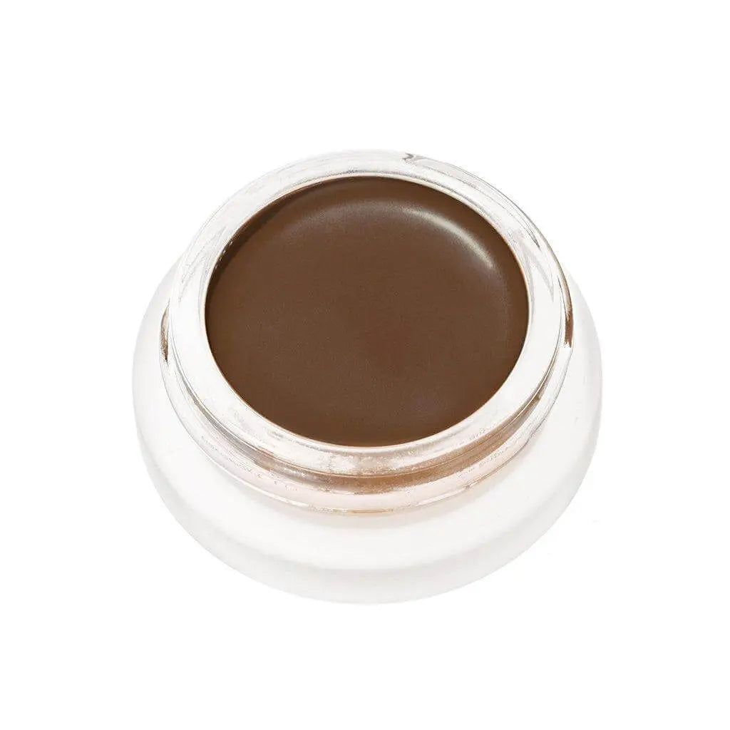 RMS Beauty UnCoverup Concealer in a compact container, showcasing the creamy cosmetic formula for flawless skin coverage.